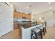 Modern kitchen with a large island featuring seating, stainless appliances, and granite countertops at 24117 N 165Th Dr, Surprise, AZ 85387