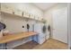 Laundry room with workspace and overhead storage at 24117 N 165Th Dr, Surprise, AZ 85387