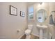 This powder room has a pedestal sink and updated fixtures at 24117 N 165Th Dr, Surprise, AZ 85387