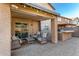 Cozy covered back patio with outdoor kitchen, seating area, and paved flooring at 2435 W Via Dona Rd, Phoenix, AZ 85085