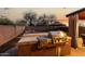 Outdoor kitchen featuring a built-in grill, gazebo, and firepit creating an entertainer's paradise at 2435 W Via Dona Rd, Phoenix, AZ 85085