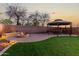 Inviting backyard with gazebo, firepit, pavers, and artificial grass creating a relaxing outdoor space at 2435 W Via Dona Rd, Phoenix, AZ 85085