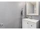 Neutral bathroom with a single sink vanity, white cabinet, chrome faucet and towel rack at 2435 W Via Dona Rd, Phoenix, AZ 85085