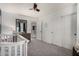 Bright Bedroom with a white crib, soft carpet, and ample closet space, creating a peaceful and organized area at 2435 W Via Dona Rd, Phoenix, AZ 85085