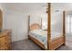 Serene bedroom featuring a canopy bed, dresser, ceiling fan, and natural light, creating a tranquil atmosphere at 2435 W Via Dona Rd, Phoenix, AZ 85085