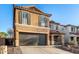 Attractive two-story home showing a spacious driveway and xeriscaped front yard with desert vegetation at 2435 W Via Dona Rd, Phoenix, AZ 85085