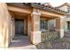 Close-up of an inviting front porch with stone accents, decorative wreath, and clear address numbers at 2435 W Via Dona Rd, Phoenix, AZ 85085