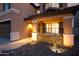 Close-up of an inviting front porch with stone accents, decorative features, and warm lighting at 2435 W Via Dona Rd, Phoenix, AZ 85085