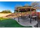 Charming gazebo with seating and dining area in a well-landscaped backyard at 2435 W Via Dona Rd, Phoenix, AZ 85085