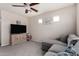 Comfortable living room featuring neutral walls, carpet, ceiling fan, and a gray sectional sofa at 2435 W Via Dona Rd, Phoenix, AZ 85085