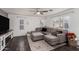 Comfortable living room with sectional sofa, ceiling fan, and bright windows, great for relaxing and unwinding at 2435 W Via Dona Rd, Phoenix, AZ 85085