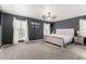 Main bedroom featuring gray walls, carpet, ceiling fan, and an inviting white bed at 2435 W Via Dona Rd, Phoenix, AZ 85085