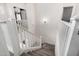 Carpeted staircase with white railings, leading to the upper level of the home at 2435 W Via Dona Rd, Phoenix, AZ 85085