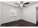 Bedroom with hardwood floors, a ceiling fan, white brick accent wall and a white window shutter at 3046 N 32Nd St # 328, Phoenix, AZ 85018