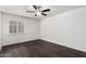 Bedroom with hardwood floors, a ceiling fan, white brick accent wall and a white window shutter at 3046 N 32Nd St # 328, Phoenix, AZ 85018