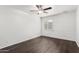 Bright bedroom with dark wood-look floors, brick accent wall, and ceiling fan at 3046 N 32Nd St # 328, Phoenix, AZ 85018