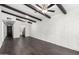 Inviting living room featuring dark wood floors, ceiling fans, and a striking white brick wall with exposed dark wood beams at 3046 N 32Nd St # 328, Phoenix, AZ 85018