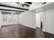 Bright living room featuring dark wood-look floors, shuttered windows and an open doorway to a secondary room at 3046 N 32Nd St # 328, Phoenix, AZ 85018