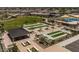 Explore aerial view of community amenities including bocce ball, pool, sports courts, and playground at 34997 N Sacramento Wash Rd, San Tan Valley, AZ 85144