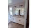 Bathroom featuring double vanity with granite countertops, modern fixtures and large mirror at 34997 N Sacramento Wash Rd, San Tan Valley, AZ 85144