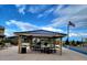 Community outdoor grilling area with shaded pavilion, picnic tables, and a barbecue for social gatherings at 34997 N Sacramento Wash Rd, San Tan Valley, AZ 85144