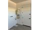 Utility room featuring a modern tankless water heater and access door at 34997 N Sacramento Wash Rd, San Tan Valley, AZ 85144