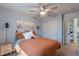 Bright bedroom with a large window, ceiling fan and closet, complemented by desert-themed decor at 3507 E Jasper Dr, Gilbert, AZ 85296