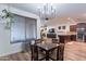 Cozy dining room featuring a chandelier, wood floors, and an open layout to kitchen at 3507 E Jasper Dr, Gilbert, AZ 85296