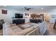 Open-concept living area flowing into a kitchen with bar seating and modern finishes at 3507 E Jasper Dr, Gilbert, AZ 85296