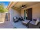 Relaxing covered patio features comfortable seating and a ceiling fan at 3507 E Jasper Dr, Gilbert, AZ 85296