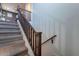 Carpeted staircase with wooden railing leading to the second floor of the home at 3507 E Jasper Dr, Gilbert, AZ 85296