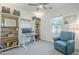 Bright bedroom featuring a ceiling fan, shelves and a comfortable blue armchair at 4077 S Sabrina Dr # 138, Chandler, AZ 85248