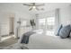 Sunlit bedroom with large windows, a dresser, and a view into the ensuite bathroom at 4077 S Sabrina Dr # 138, Chandler, AZ 85248