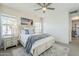 Bedroom with a ceiling fan, beach-themed wall art, bedside table, and view to the ensuite bathroom at 4077 S Sabrina Dr # 138, Chandler, AZ 85248