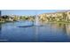 Scenic view of a tranquil lake with fountains and well-maintained landscaping at 4077 S Sabrina Dr # 138, Chandler, AZ 85248