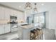 Well-lit kitchen featuring a kitchen island with seating, modern appliances, and a dining nook at 4077 S Sabrina Dr # 138, Chandler, AZ 85248