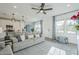 Inviting living room featuring a ceiling fan, natural light, and seamless flow into the dining and kitchen areas at 4077 S Sabrina Dr # 138, Chandler, AZ 85248