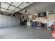 Spacious garage featuring abundant storage cabinets and clean, epoxy-coated flooring at 41615 W Caliente Dr, Maricopa, AZ 85138
