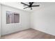 A bright bedroom with wood flooring and ceiling fan at 43795 W Sagebrush Trl, Maricopa, AZ 85138