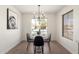 Cozy dining area illuminated by a modern chandelier, perfect for intimate meals at 43795 W Sagebrush Trl, Maricopa, AZ 85138