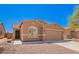 Charming single-story home featuring a two-car garage and desert landscaping at 43795 W Sagebrush Trl, Maricopa, AZ 85138