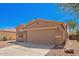 Charming single-story home featuring a two-car garage, desert landscaping, and a tile roof at 43795 W Sagebrush Trl, Maricopa, AZ 85138