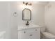 This bathroom features a modern vanity with vanity lighting, framed mirror, and white walls at 458 N Drew W St # West, Mesa, AZ 85201