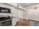 A bright kitchen featuring stainless steel appliances, stone countertops, white cabinets, and a breakfast bar at 458 N Drew W St # West, Mesa, AZ 85201