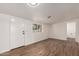 Spacious living room with wood-look floors, a window, and fresh white paint offers a bright and modern feel at 458 N Drew W St # West, Mesa, AZ 85201