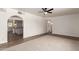 Spacious living room featuring a ceiling fan, neutral carpet, and arched doorway at 458 N Drew W St # West, Mesa, AZ 85201