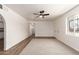 Bright living room with ceiling fan, plush carpet, and a large window for natural light at 458 N Drew W St # West, Mesa, AZ 85201