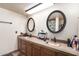 Bathroom featuring double sinks with bronze fixtures and large mirrors at 4721 W Eva St, Glendale, AZ 85302