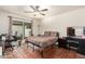 Bedroom with tile floors, ceiling fan, and sliding glass doors to a patio at 4721 W Eva St, Glendale, AZ 85302