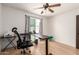 Bedroom featuring wood floors, a ceiling fan, and a work desk at 4721 W Eva St, Glendale, AZ 85302